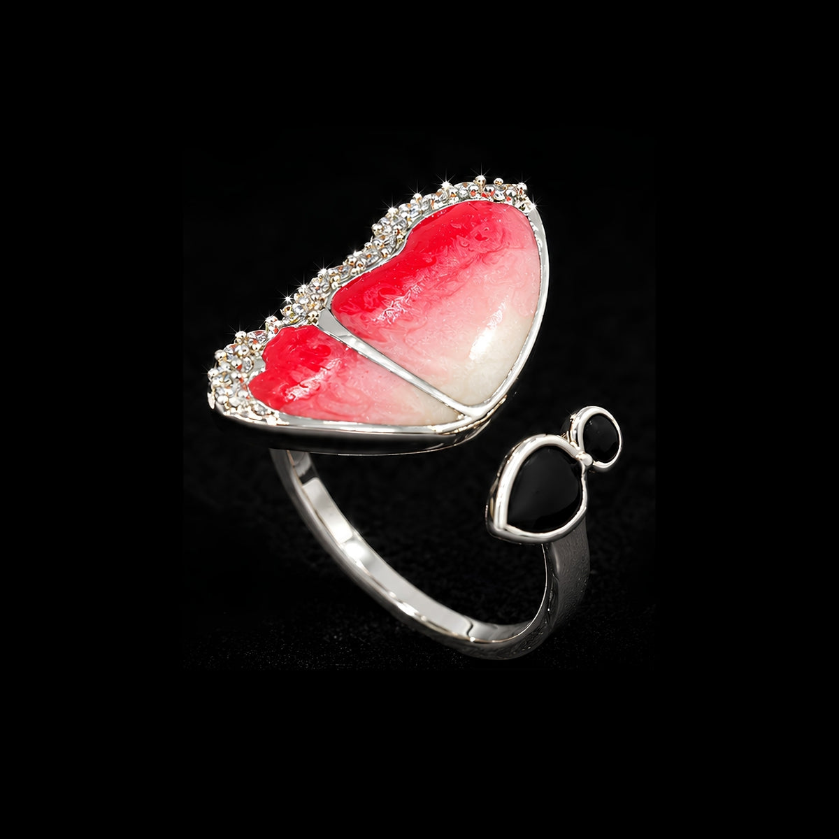 A silver ring with a heart-shaped design and clear CZ stones.