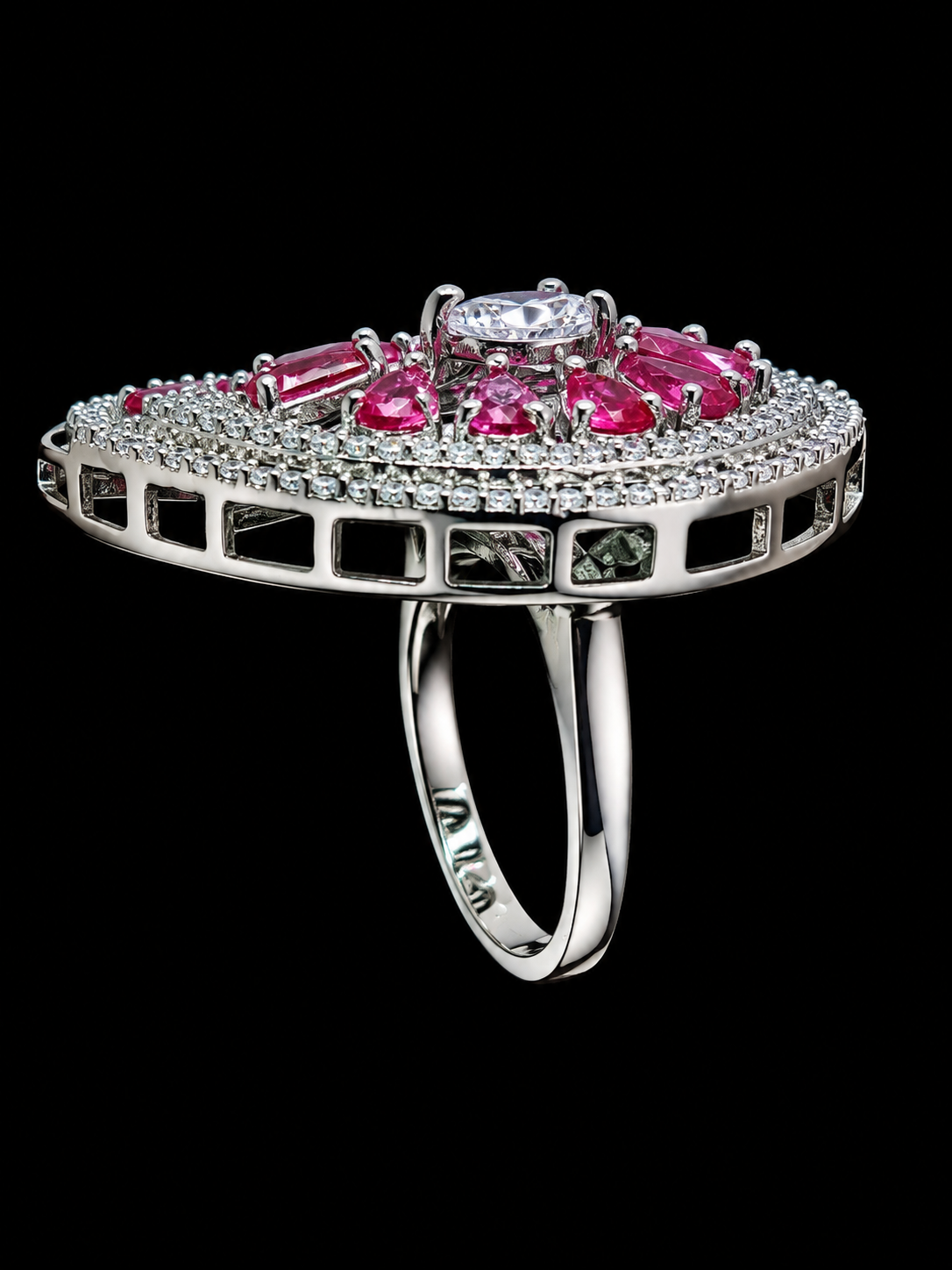 A silver ring with a cluster of pink CZ stones, set in a floral design.