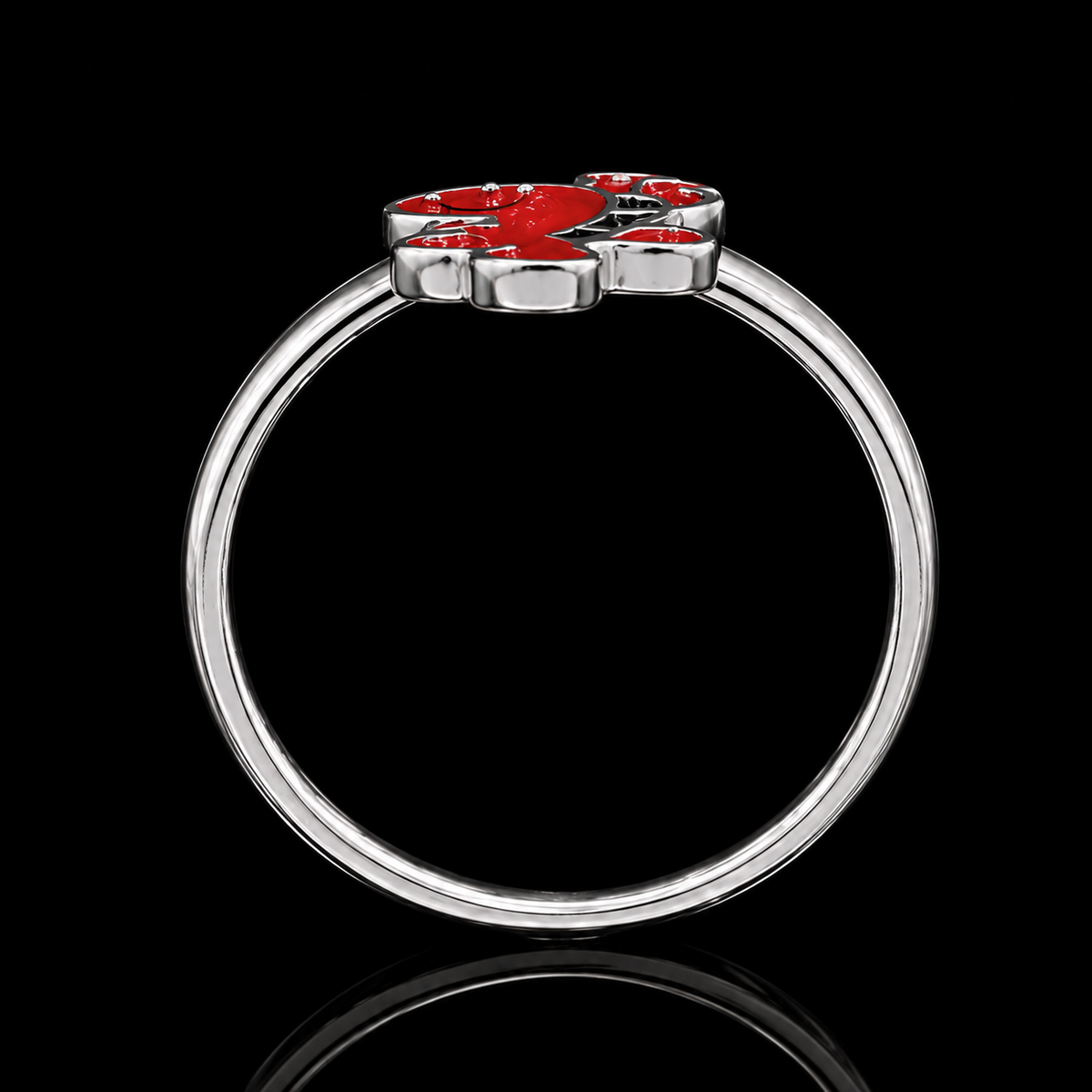 A silver-tone ring with a red enamel flower design and CZ stones.