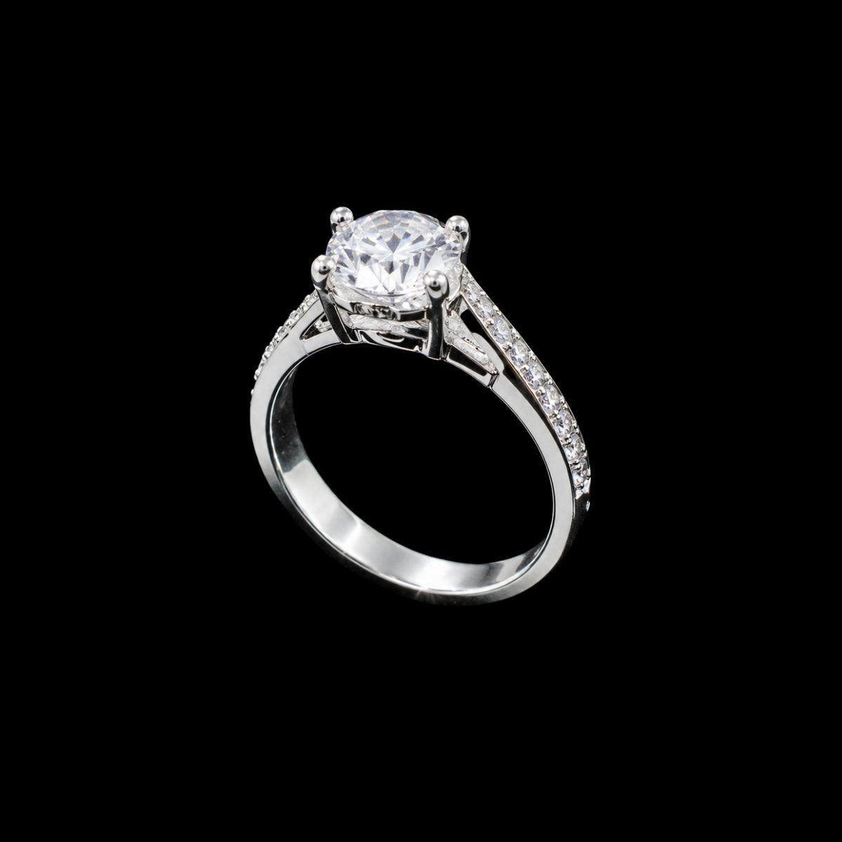 A silver-tone ring with a round-cut cubic zirconia stone and smaller stones on the band.