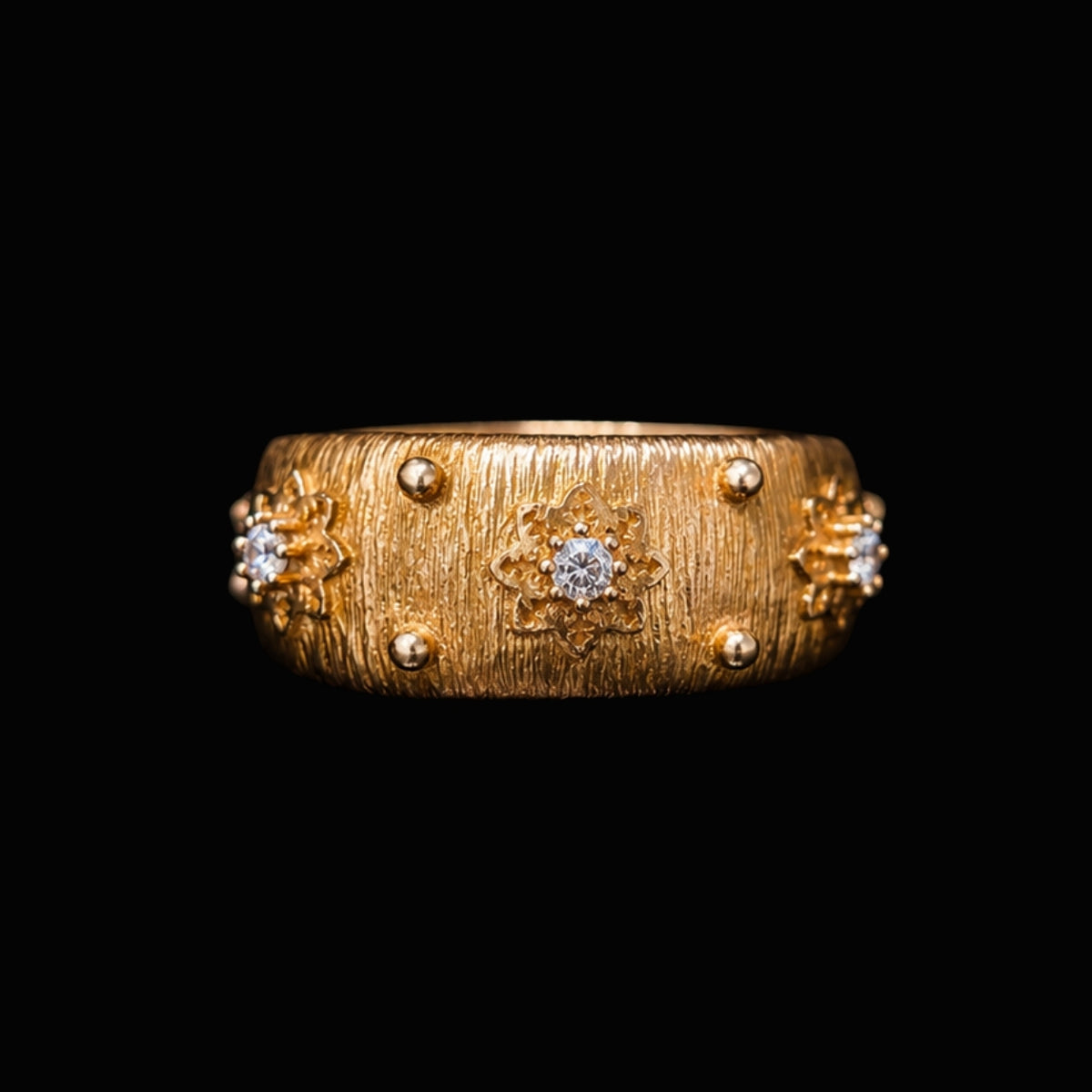 A gold-tone ring with a textured finish and CZ stones set in a floral motif.