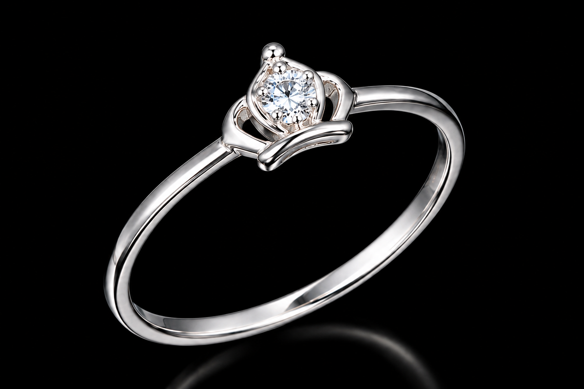 A silver ring with a round-cut cubic zirconia stone on a black background.