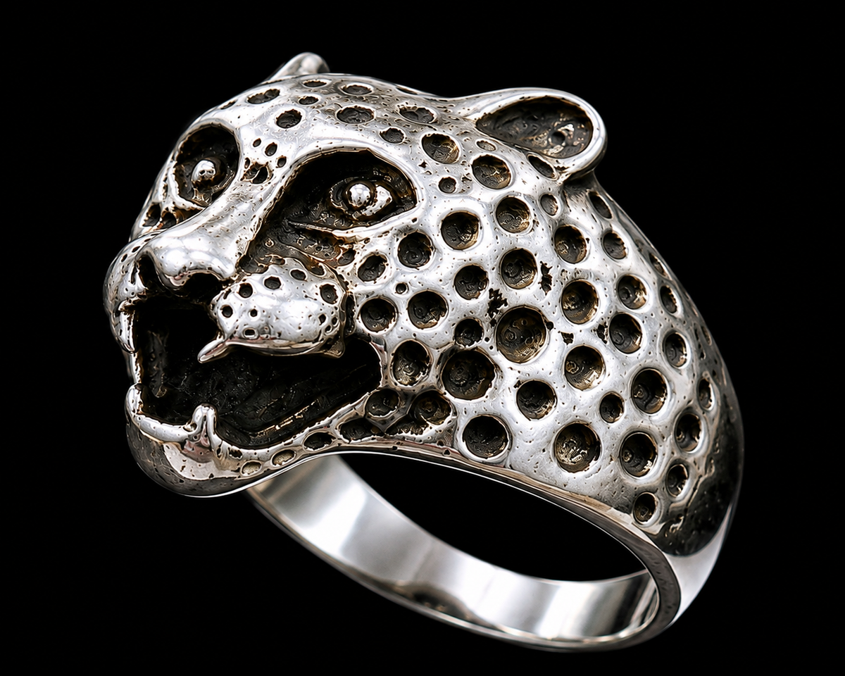 A silver ring featuring a detailed cheetah head design with CZ stones.