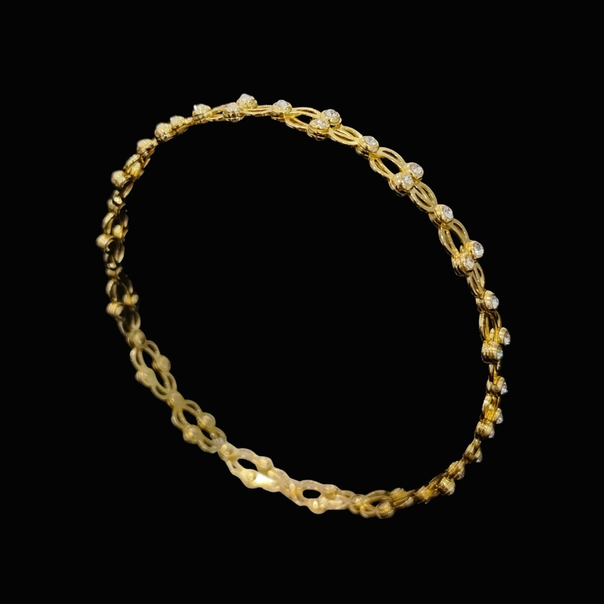 A gold-tone chain bracelet with clear cubic zirconia stones.
