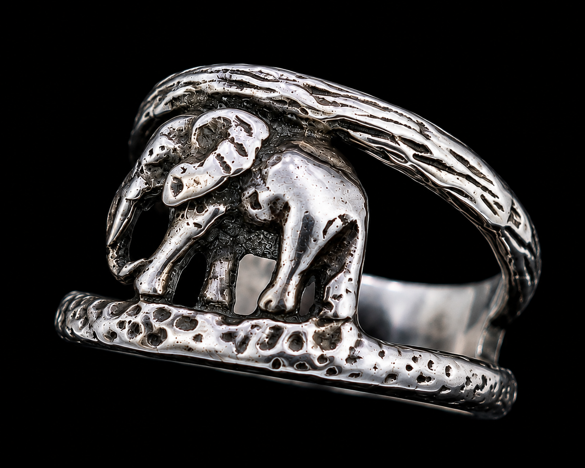 A silver ring with an enamel elephant design.