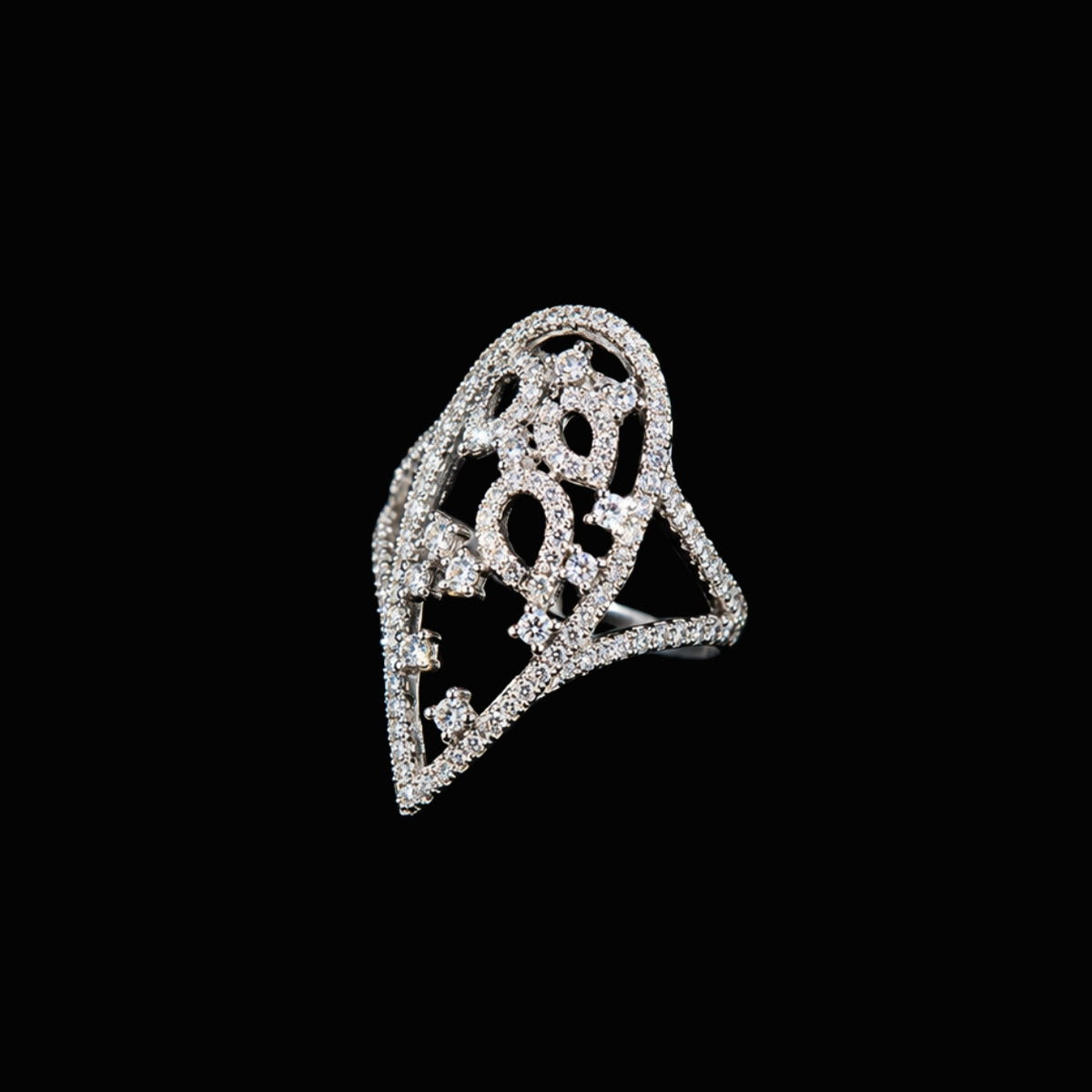 A silver ring with an intricate design and CZ stones.