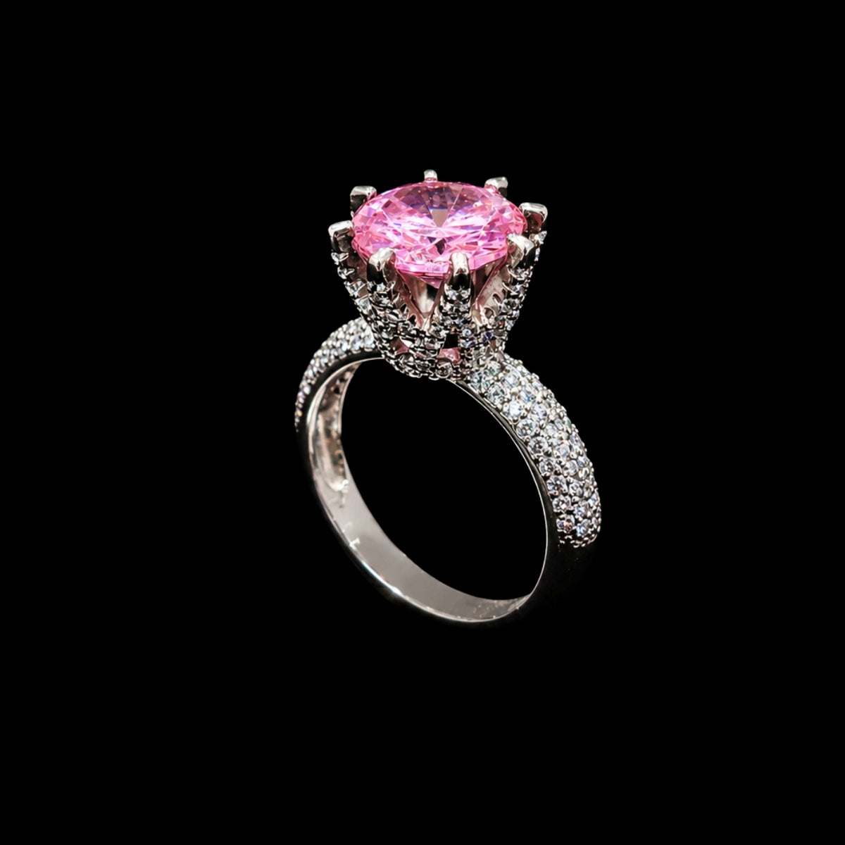 A silver-tone ring with a large pink CZ stone and smaller clear stones.
