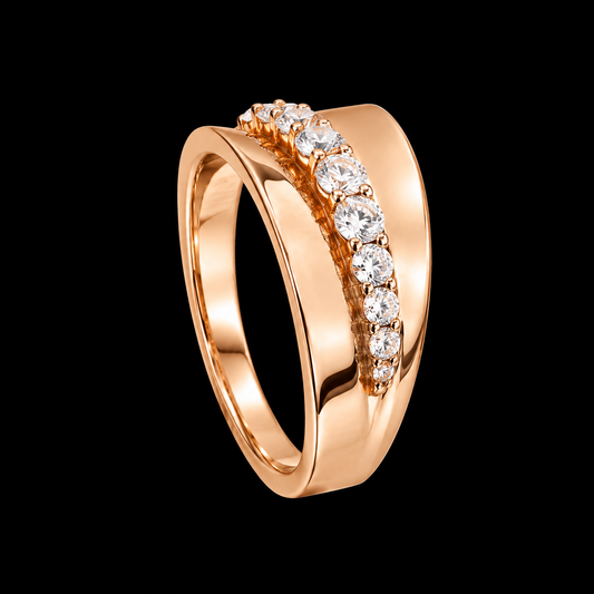 A gold-tone ring with a row of clear cubic zirconia stones set in a prong setting.