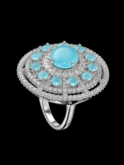 A silver-tone ring with a large blue stone and smaller blue and clear stones.
