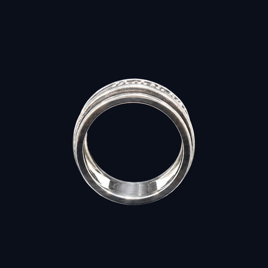 A silver ring with a band of clear cubic zirconia stones set into it.