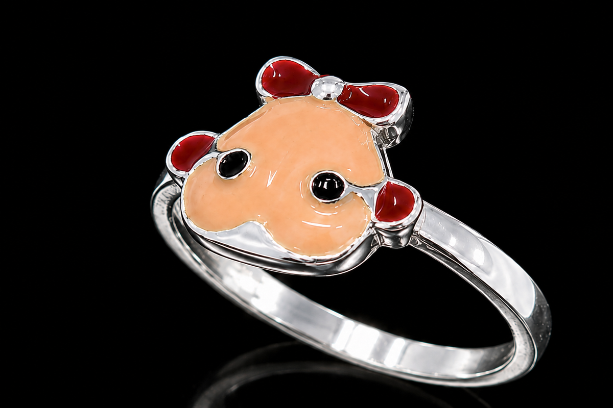 A silver ring with a cow face design and CZ stones, set against a black background.
