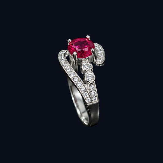 A silver ring with a ruby stone and CZ accents