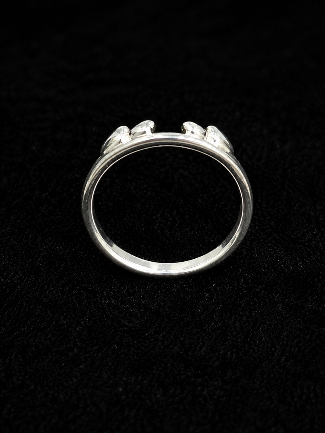 A silver-tone ring with three round-cut CZ stones set in a minimalist design.
