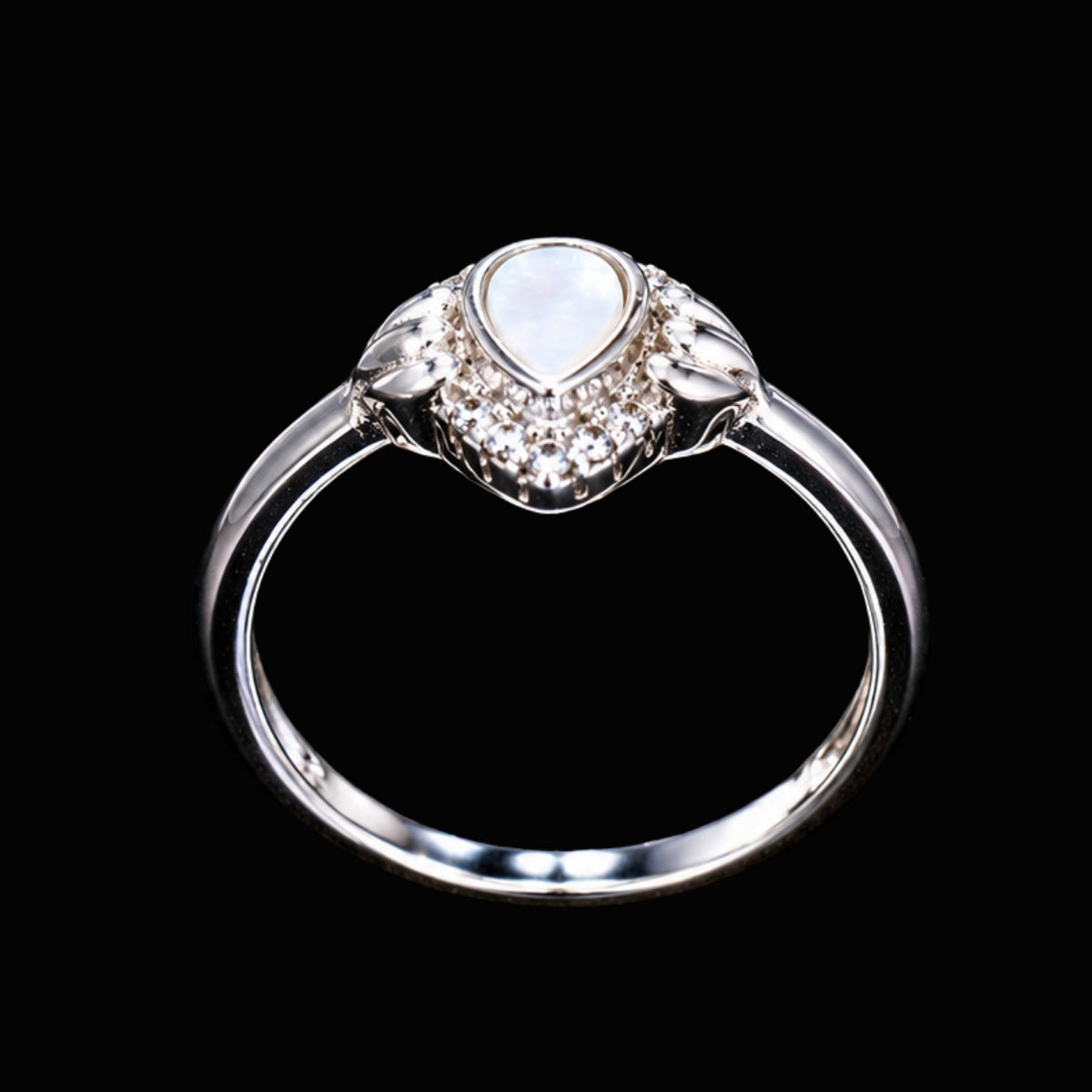 A silver ring with a heart-shaped CZ stone, set against a dark background.