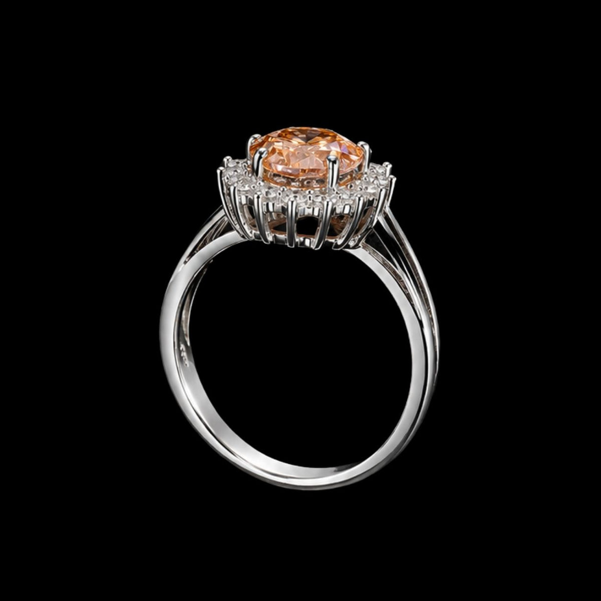 A silver ring with a peach-colored CZ stone at its center, surrounded by smaller stones.