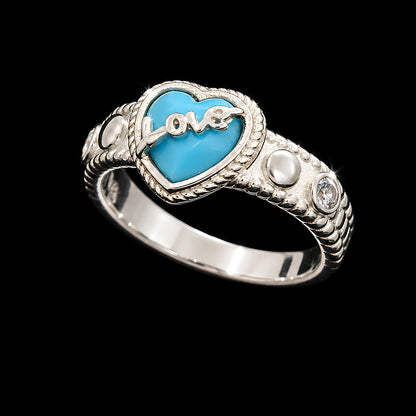A silver-tone ring featuring a heart-shaped design with a turquoise enamel center and a silver-tone 'love' script in the middle.