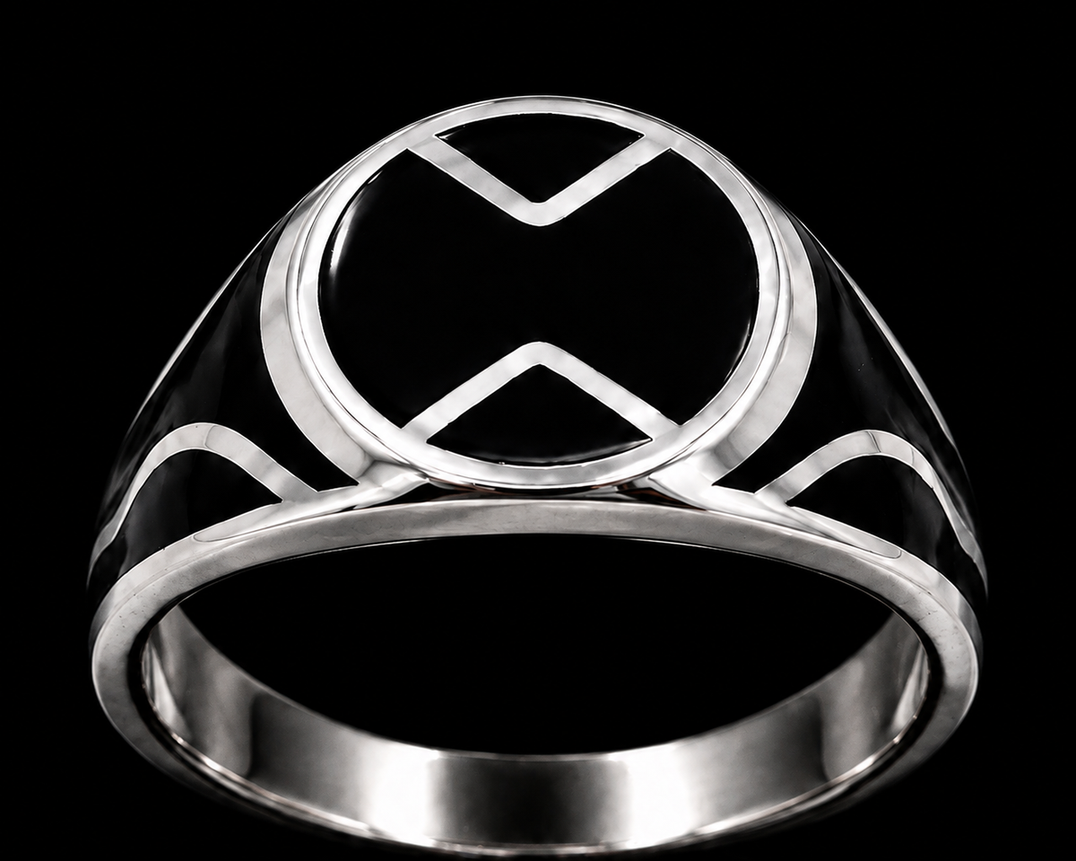 A silver ring with an enamel design on a plain background