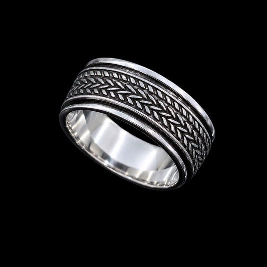 A silver band ring with intricate enamel work and a simple closure.