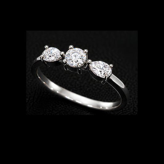 A silver-tone ring with three round-cut cubic zirconia stones set in a minimalist design.