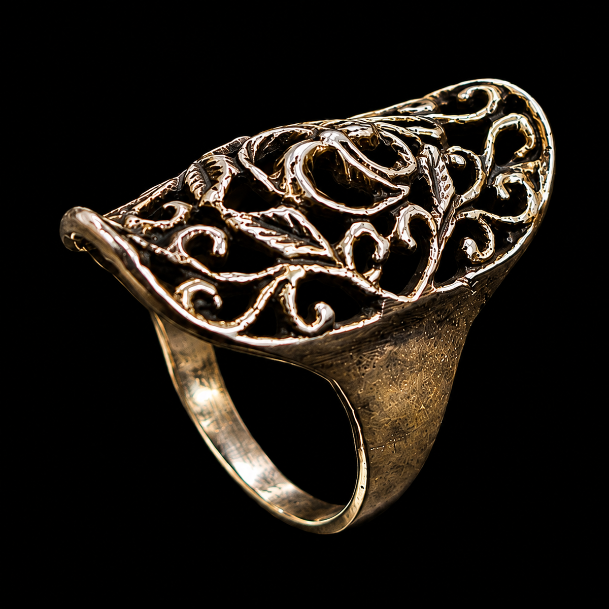 A gold-tone ring with an engraved design.