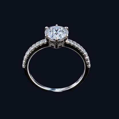 A silver-tone ring with a large cubic zirconia stone, set in a classic solitaire design.