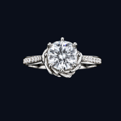 A silver ring with a round-cut CZ stone and rose gold setting.