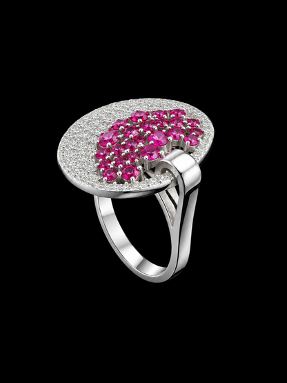 A silver ring with a cluster of pink CZ stones on a black background