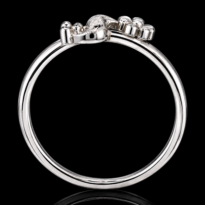 A silver ring with a lion's head motif on a black background