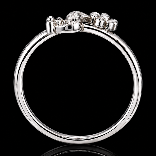 A silver ring with a lion's head motif on a black background