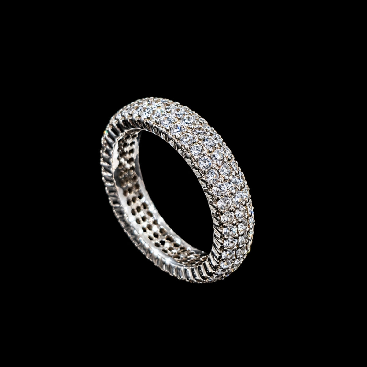 A silver ring with a row of clear cubic zirconia stones.