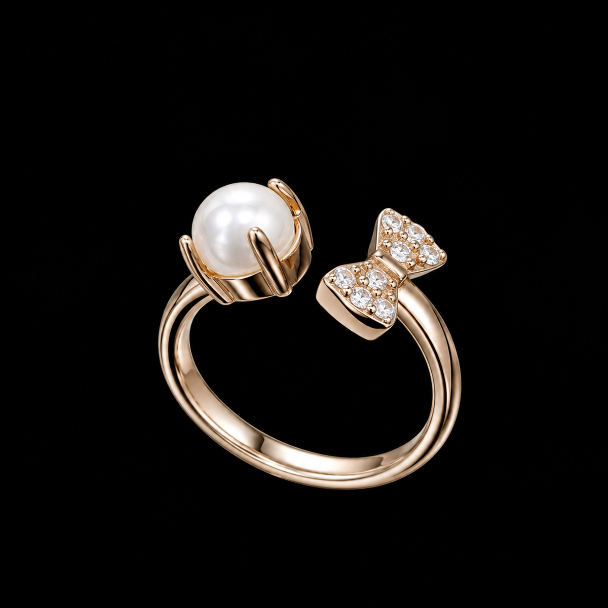 A gold ring with a pearl and CZ bow design.