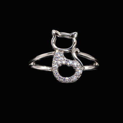 A silver-tone ring with a cat design and clear cubic zirconia stones.