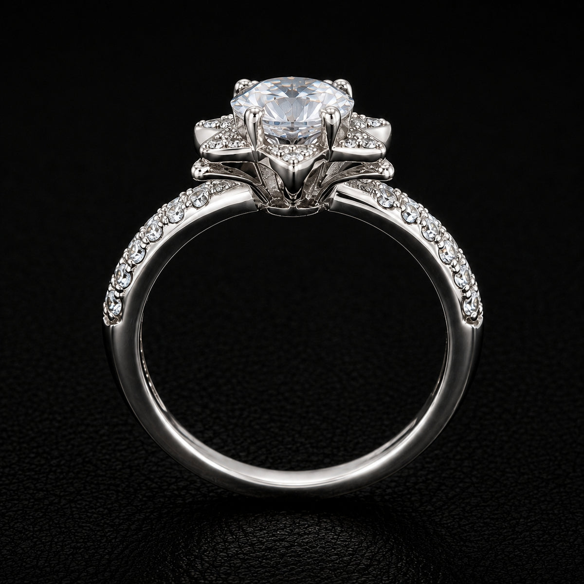 A silver-tone ring with a large, round-cut CZ stone at the top and smaller CZ stones along the band.