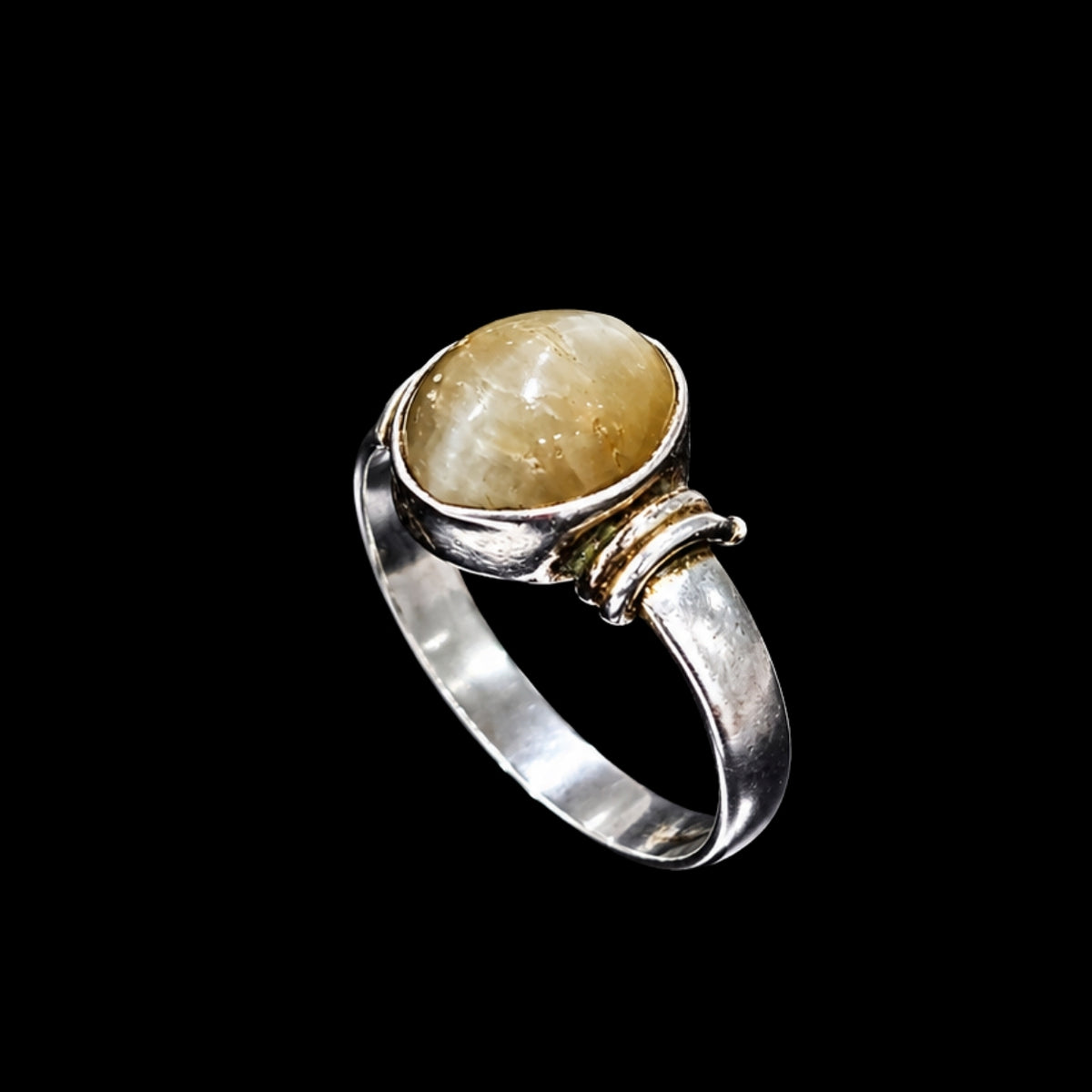 A silver ring with a yellow CZ stone, set in a simple design.