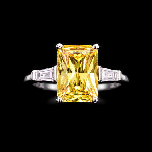 A silver ring with a large yellow CZ stone in the center, set against a black background.