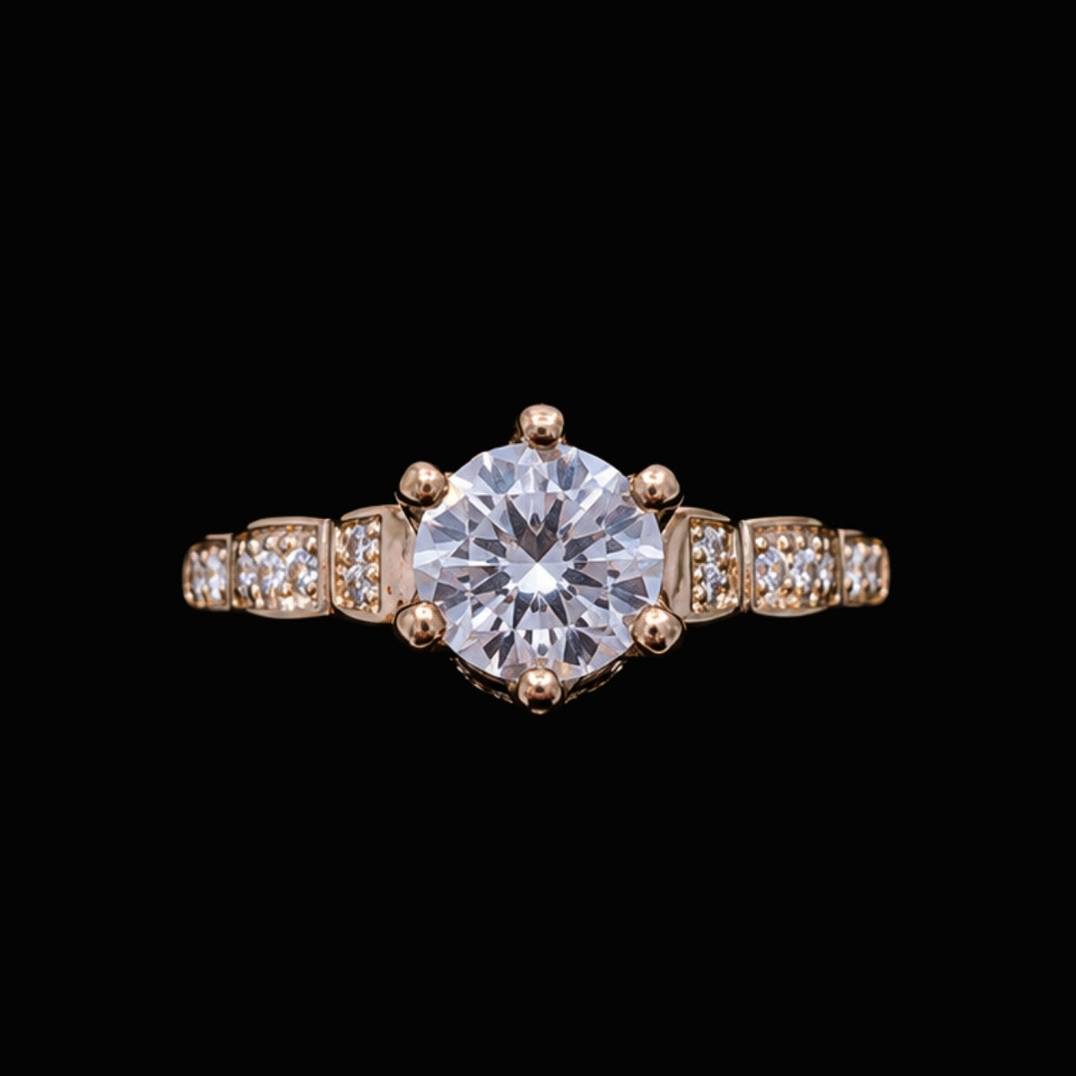 A gold-tone ring with a large round-cut CZ stone and smaller CZ stones on a delicate gold-tone band.