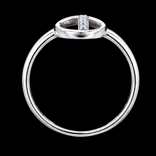 A silver ring with a row of clear cubic zirconia stones on a black background.