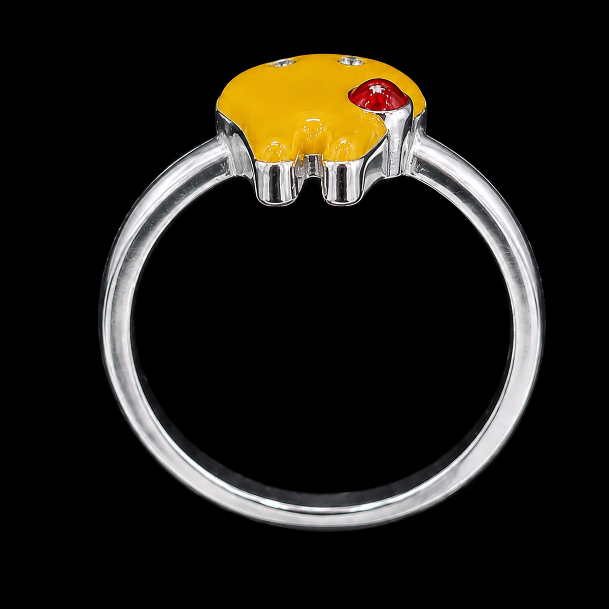 A silver-tone ring featuring a yellow enamel top with a red enamel accent and a single clear CZ stone.