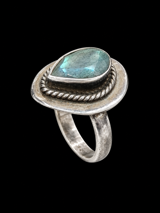 A silver ring with a blue teardrop-shaped CZ stone.