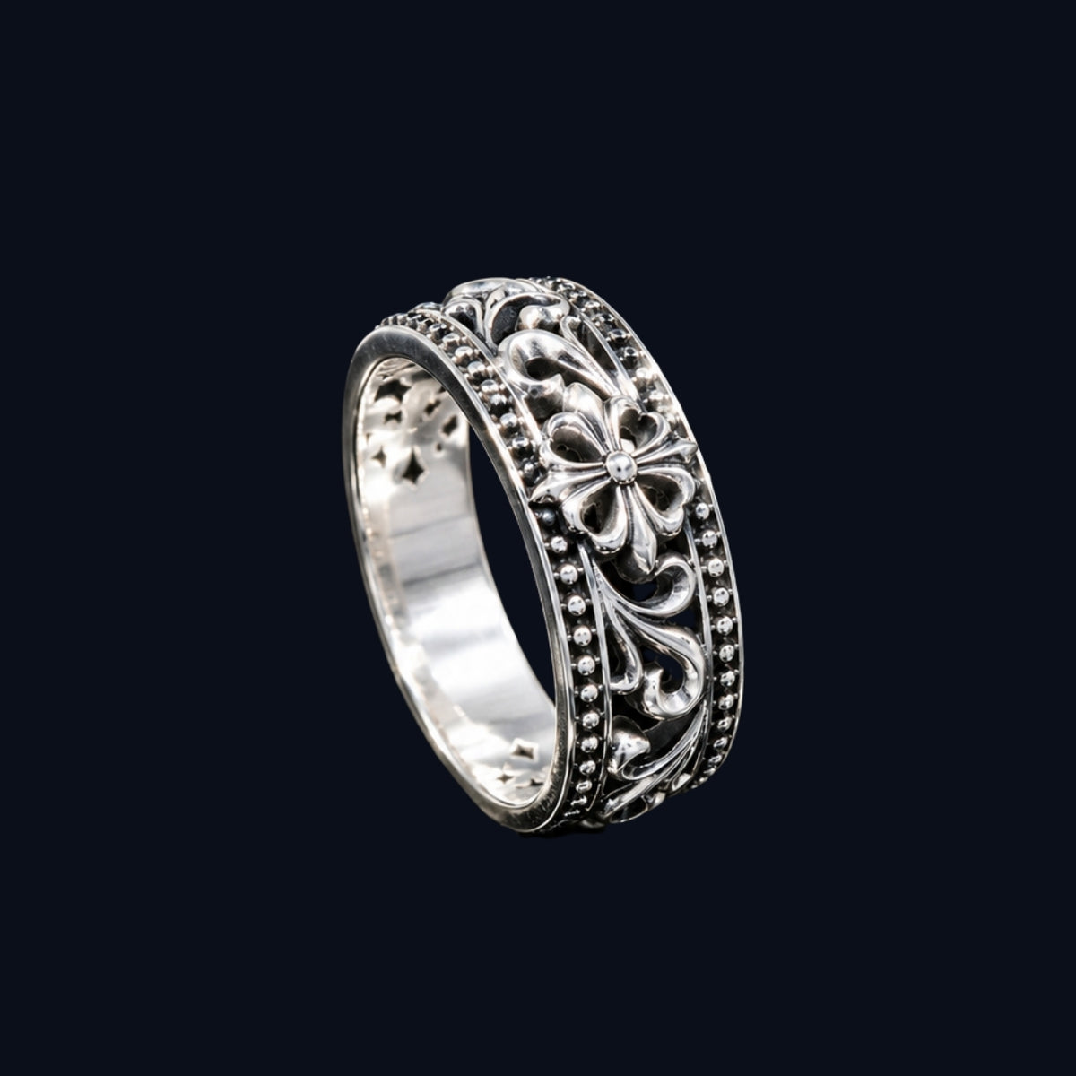 A silver ring with a floral design and CZ stones