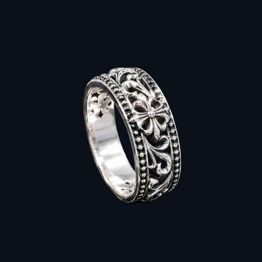 A silver ring with a floral design and CZ stones