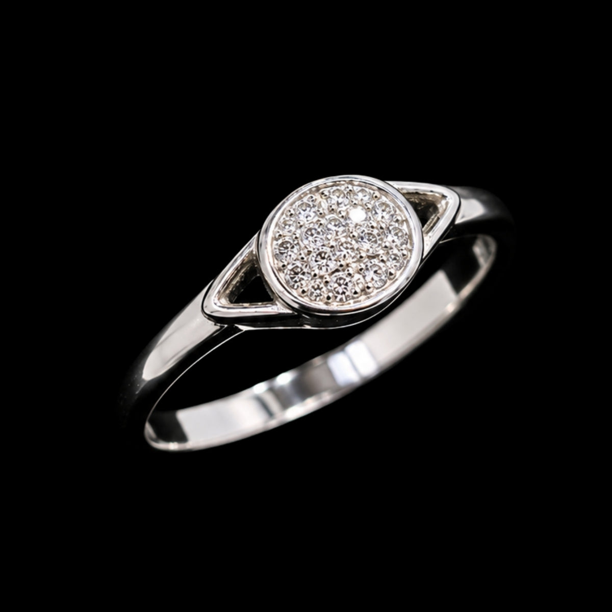A silver ring with a round cluster of clear cubic zirconia stones.