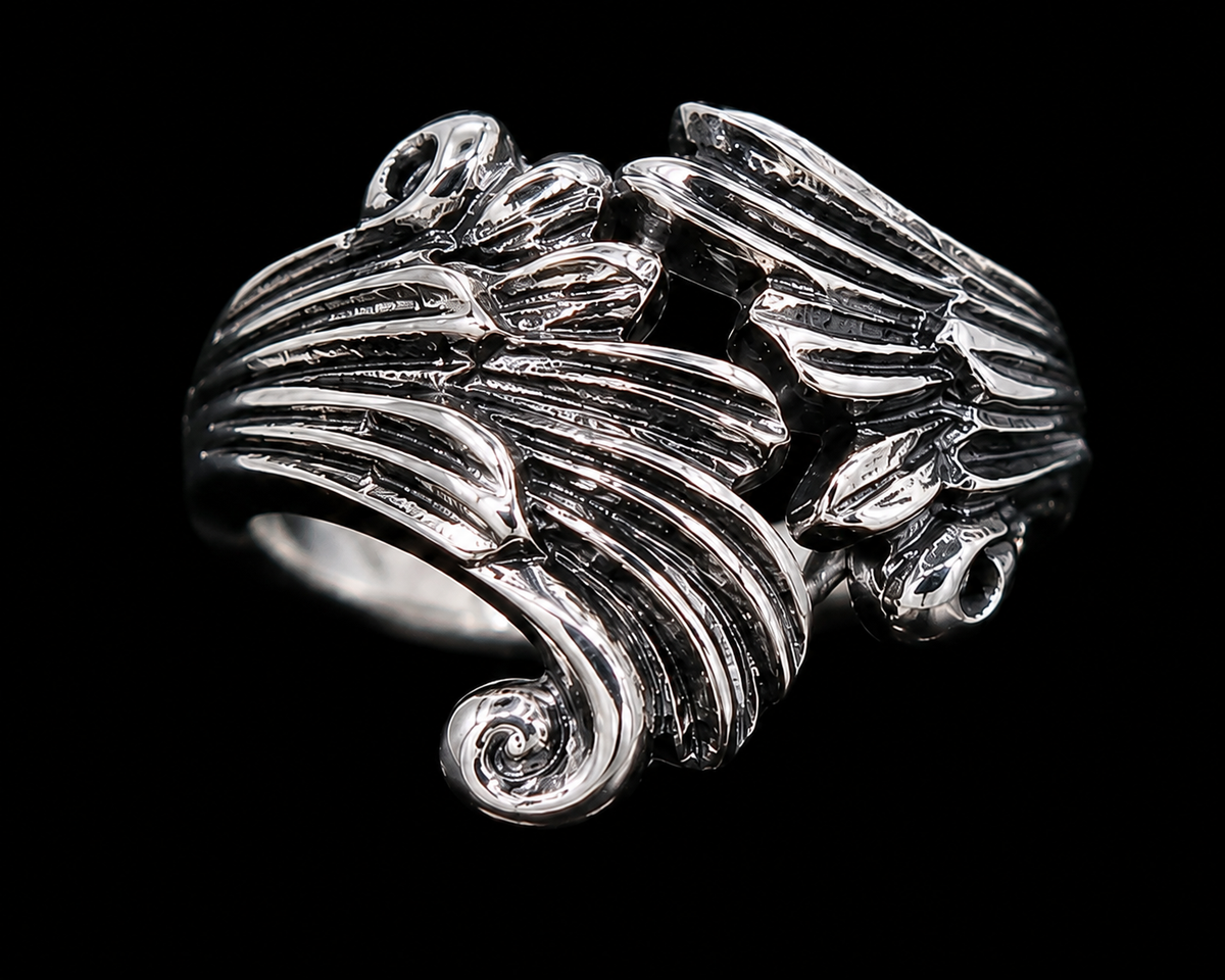 A silver ring with intricate enamel work, set against a plain background.