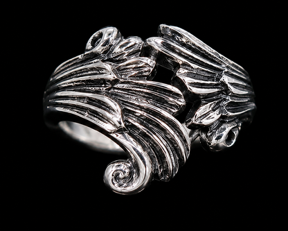 A silver ring with intricate enamel work, set against a plain background.