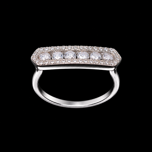 A silver ring with a row of round-cut cubic zirconia stones on a black background.