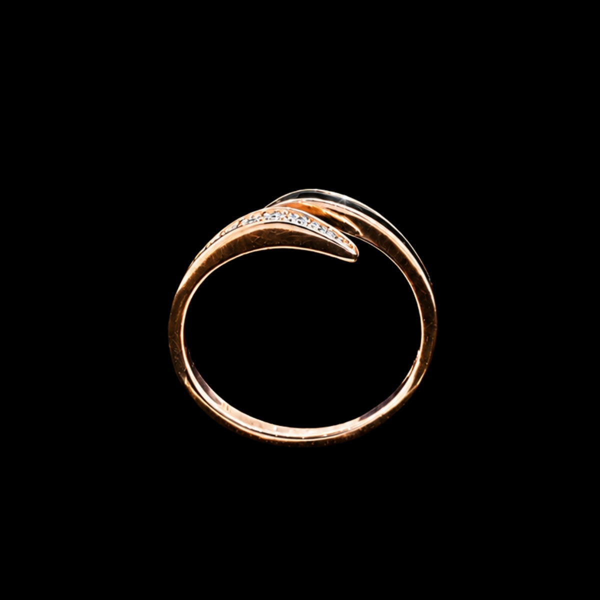 A gold-tone ring with a curved design and CZ stones.