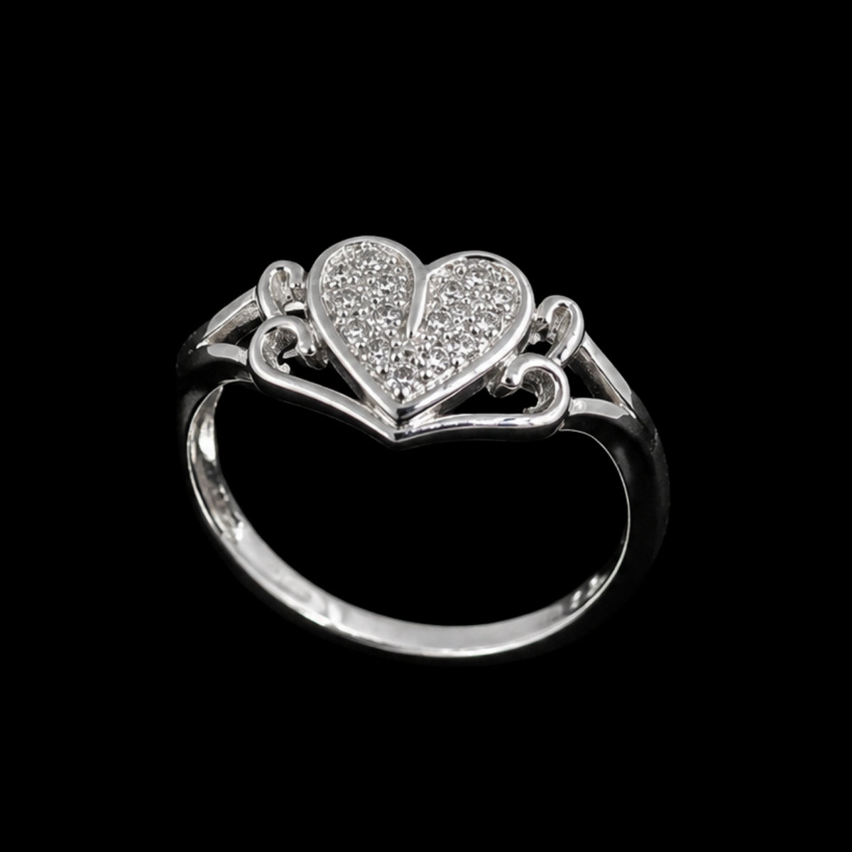 A silver-tone ring with a heart-shaped motif and clear cubic zirconia stones.