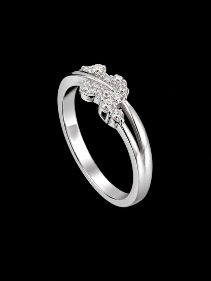 A silver ring with a cluster of clear cubic zirconia stones on a black background.