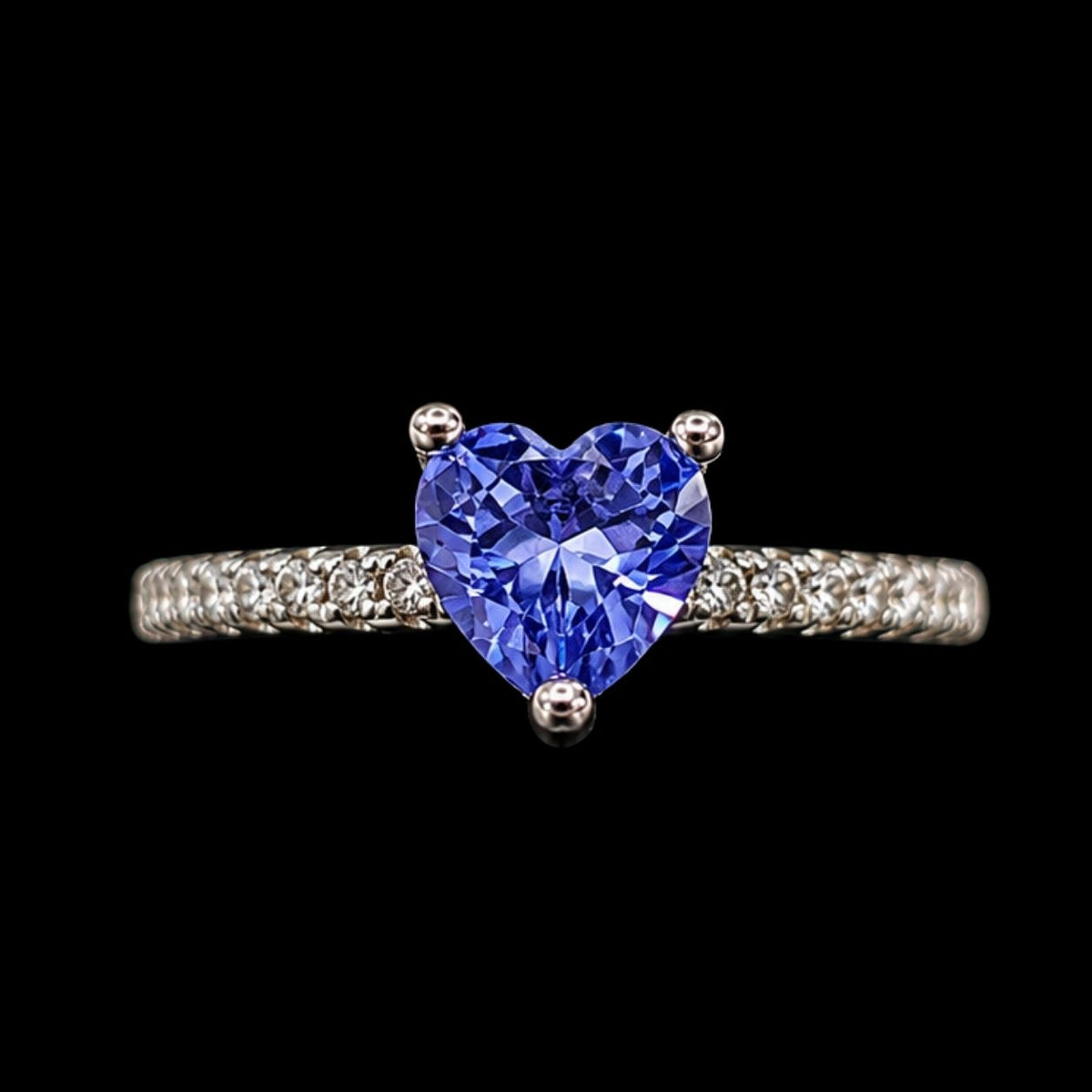 A silver ring with a heart-shaped tanzanite stone, set on a silver band.