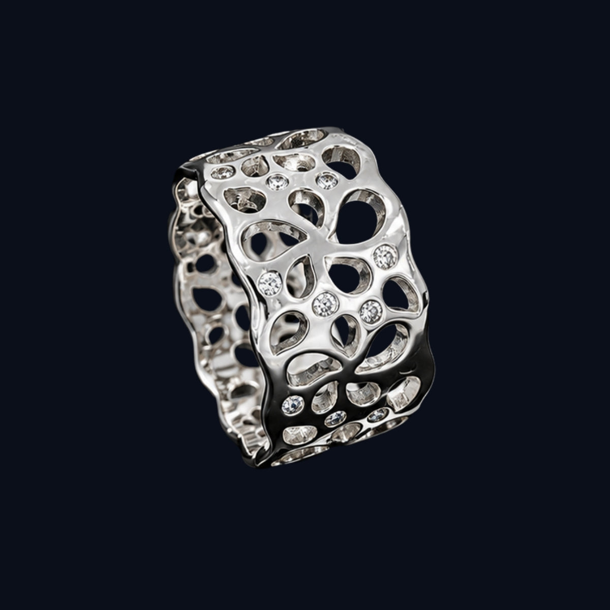 A silver ring with intricate cut-out details and sparkling CZ stones.